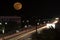 Moon and Traffic in city