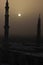 Moon between two towers of the Prophet\'s Mosque in Al Madinah, Saudi Arabia