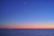 Moon and venus star above ocean