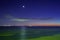 Moon and venus star above ocean