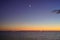 Moon and venus star above ocean