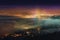 moonbow rising above a foggy cityscape