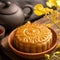 Mooncake, Moon cake for Mid-Autumn Festival, concept of traditional festive food on black slate table with tea and yellow flower,