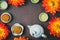 Mooncakes in a fresh orange dahlia flowers, a blue teapot and cups of green tea on a brown background. Chinese mid-autumn festival