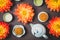 Mooncakes in a fresh orange dahlia flowers, a blue teapot and cups of green tea on a brown background. Chinese mid-autumn festival