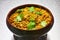 Moong Dal, indian vegetarian lentil soup in terra cotta bowl.