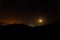 Moonlight illuminating horizontal mountain silhouette with starry sky 2