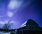 Moonlit barn with stars and clouds in winter