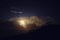 Moonlit clouds at night in the mountains