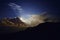 Moonlit clouds at night in the mountains