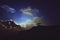 Moonlit clouds at night in the mountains