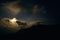 Moonlit clouds at night in the mountains