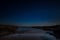 A moonlit view of the night sky over the beach at Beadnell , Northumberland in the United Kingdom