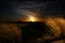 Moonrise on the coast with starts and scattered clouds