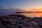 Moonrise and colorful sunset on the rugged and rocky coast