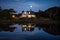 moonrise over cape cod house with reflection in water