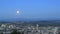 Moonrise Over Cityscape and Mountain Range at Blue Hour