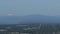 Moonrise Over Cityscape and Mountain Range with Traffic Light Trails