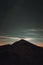 Moonrise over the mountain peak with bright clouds in the night in autumn season