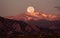 Moonset over the rocky mountains, behind Boulder Colorado