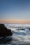 Moonset over rocky ocean