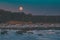 Moonset over sea coast by winter morning