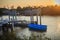 Moored blue boats with jetty at the side on canal in the evening