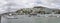 Moored boats, boathouses on shore and Mount Victoria hill with St. Gerard church, Wellington, New Zealand