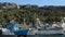 Moored boats float, people walk between boats Mediterranean sea