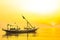 Moored boats during sunrise with yellow sky in Kenjeran, Surabaya, Indonesia.