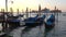 Moored gondolas on the background of Cathedral of San Giorgio Maggiore, early morning. Venice, Italy