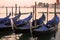 The moored gondolas in San Marco bay in the early cloudy morning. Venice, Italy