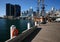 Moored historic sailing ship with iconic cityscape of modern skyscrapers on harbor waterfront, Darling Harbour, Sydney, Australia