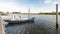 Moored iron rowing boat in rippling water