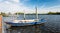 Moored iron rowing boat in rippling water