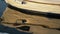 Moored rowing boat on the background of waves close-up