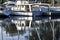 Moored sailboats reflecting in water