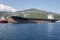 Moored tanker near the shore against the backdrop of green mount