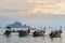 Moored thai traditional long-tail boats in the sea water near the shore in the evening on Ao nang beach in Krabi province