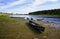 Moored to the shore near the village of long classic wooden boats of the Siberian Mansi people