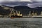 Moored for unloading / loading sea ships against the background of mountains in the clouds.