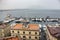 Moored yachtes and boats in port against Vesuvius volcano silhouette. Sailing and shiping concept.