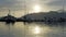 Moored yachts and motorboats at sunset