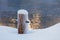 Mooring bollard covered with snow and hoarfrost
