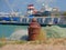 Mooring bollard with ferry boat and harbor buildings in the backgroundin the harbor of Calais