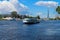 Mooring excursion boat with tourists against the backdrop of houses, towers and a blue sky with clouds. St. Petersburg