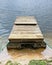 The mooring for fishing boats is made of two rusty pontoons and