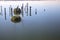 Mooring poles on a lake with reflections on a clear day