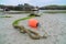 Mooring rope and buoy lying on beach