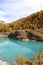 Moosjisee Lake with turquoise water and autumn colored Larch forest in Zermatt.